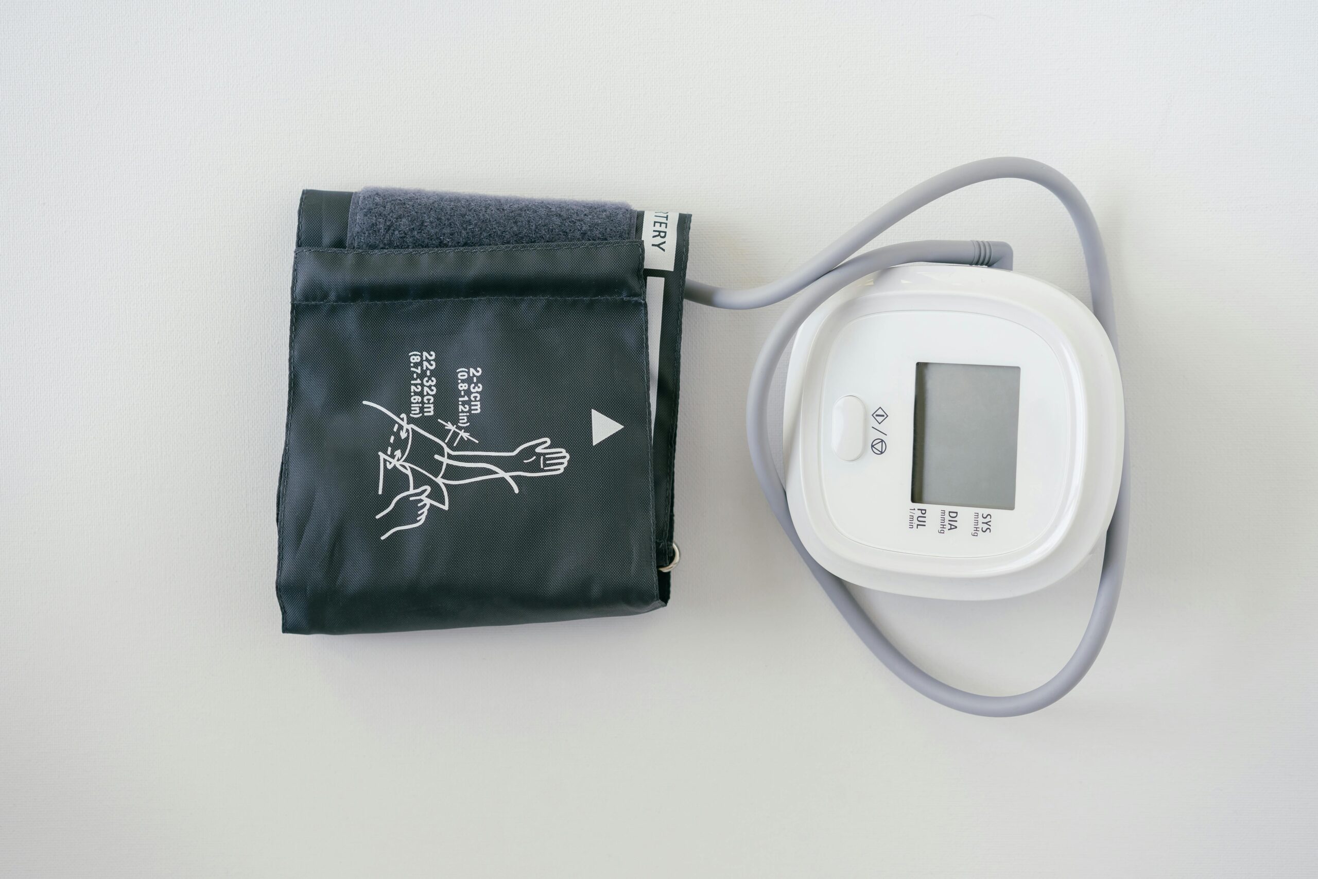 A digital sphygmomanometer on a white background, used for measuring blood pressure.