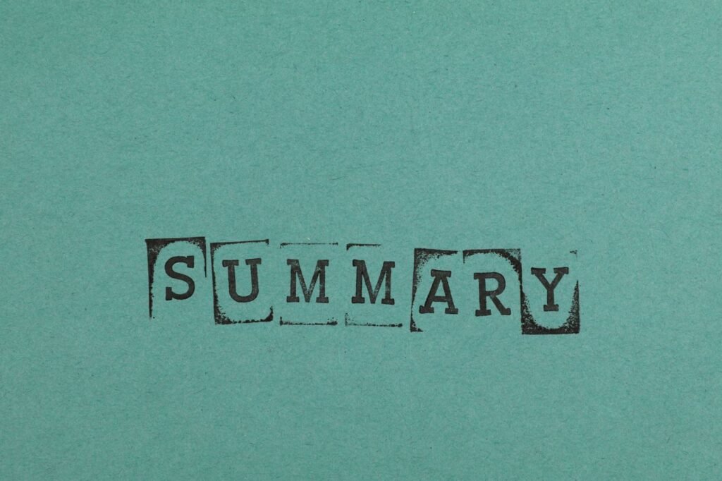 Close-up of the word 'SUMMARY' stamped on a green paper surface, offering ample copy space.